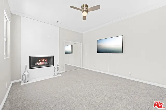 a view of a livingroom with a ceiling fan and wooden floor