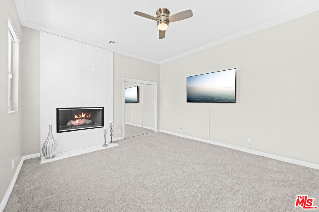 15042 Valleyheart Drive Sherman Oaks, CA 91403 - Photo 23 of 31 a view of a livingroom with a ceiling fan and wooden floor