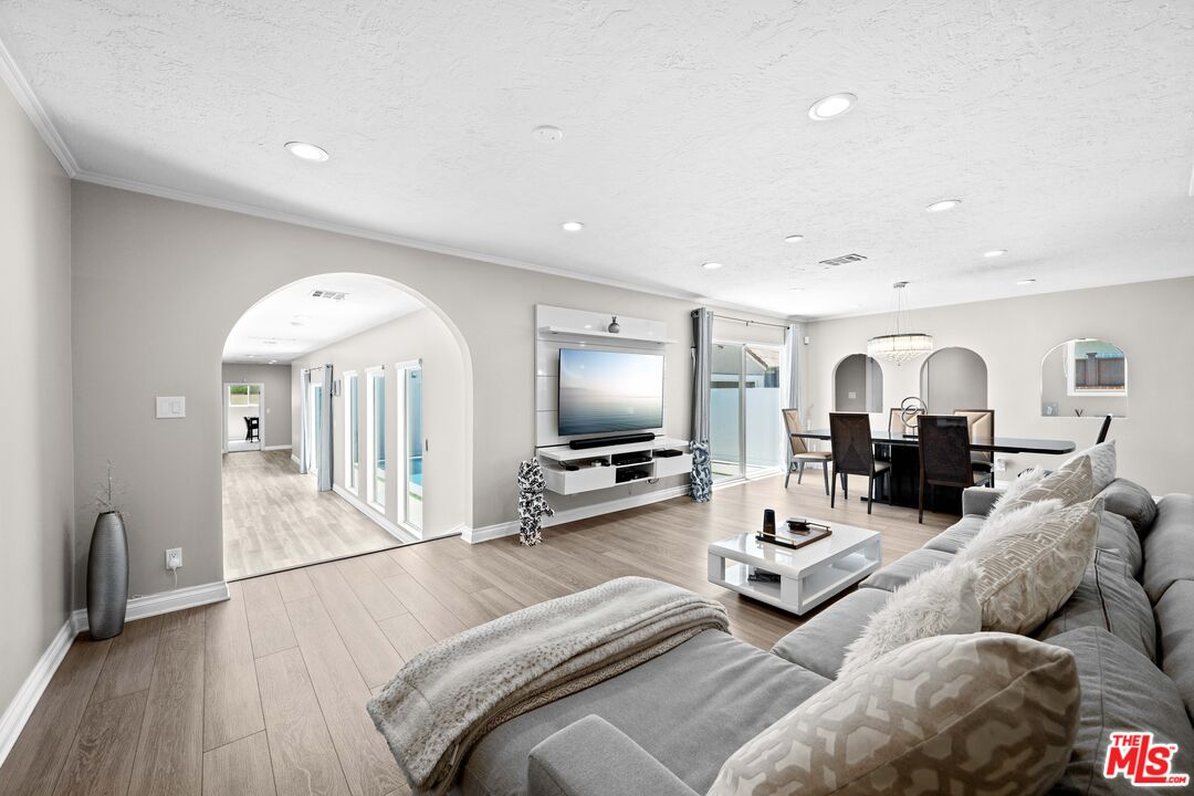 15042 Valleyheart Drive Sherman Oaks, CA 91403 - Photo 4 of 31 a living room with furniture and a flat screen tv