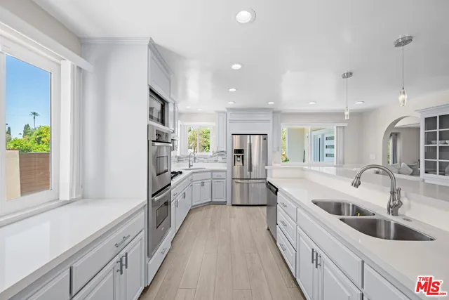 a large white kitchen with a large window