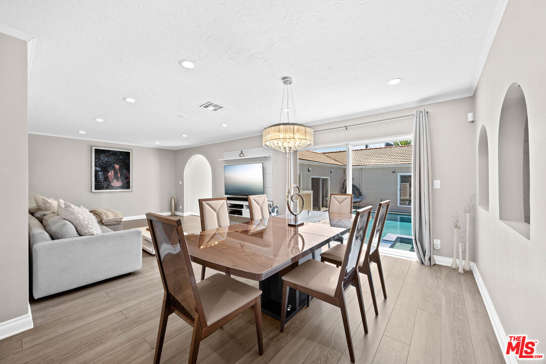 15042 Valleyheart Drive Sherman Oaks, CA 91403 - Photo 8 of 31 a view of a dining room with furniture and wooden floor