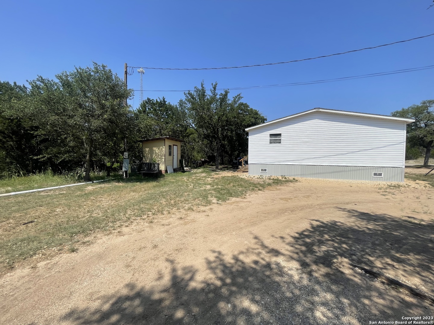 792 Alamo Beach Road, Unit A Pipe Creek, TX 78063 - Photo 14 of 18 a view of a backyard of the house