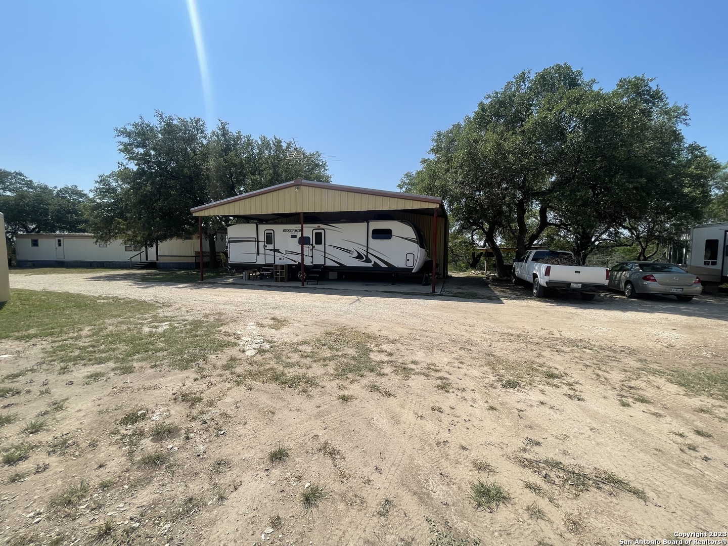 792 Alamo Beach Road, Unit A Pipe Creek, TX 78063 - Photo 15 of 18 a front view of a house with a yard
