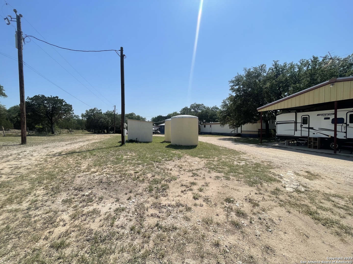 792 Alamo Beach Road, Unit A Pipe Creek, TX 78063 - Photo 16 of 18 a backyard of a house with lots of green space