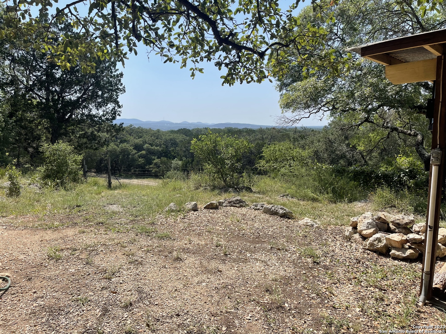 792 Alamo Beach Road, Unit A Pipe Creek, TX 78063 - Photo 17 of 18 a view of a lake with a tree