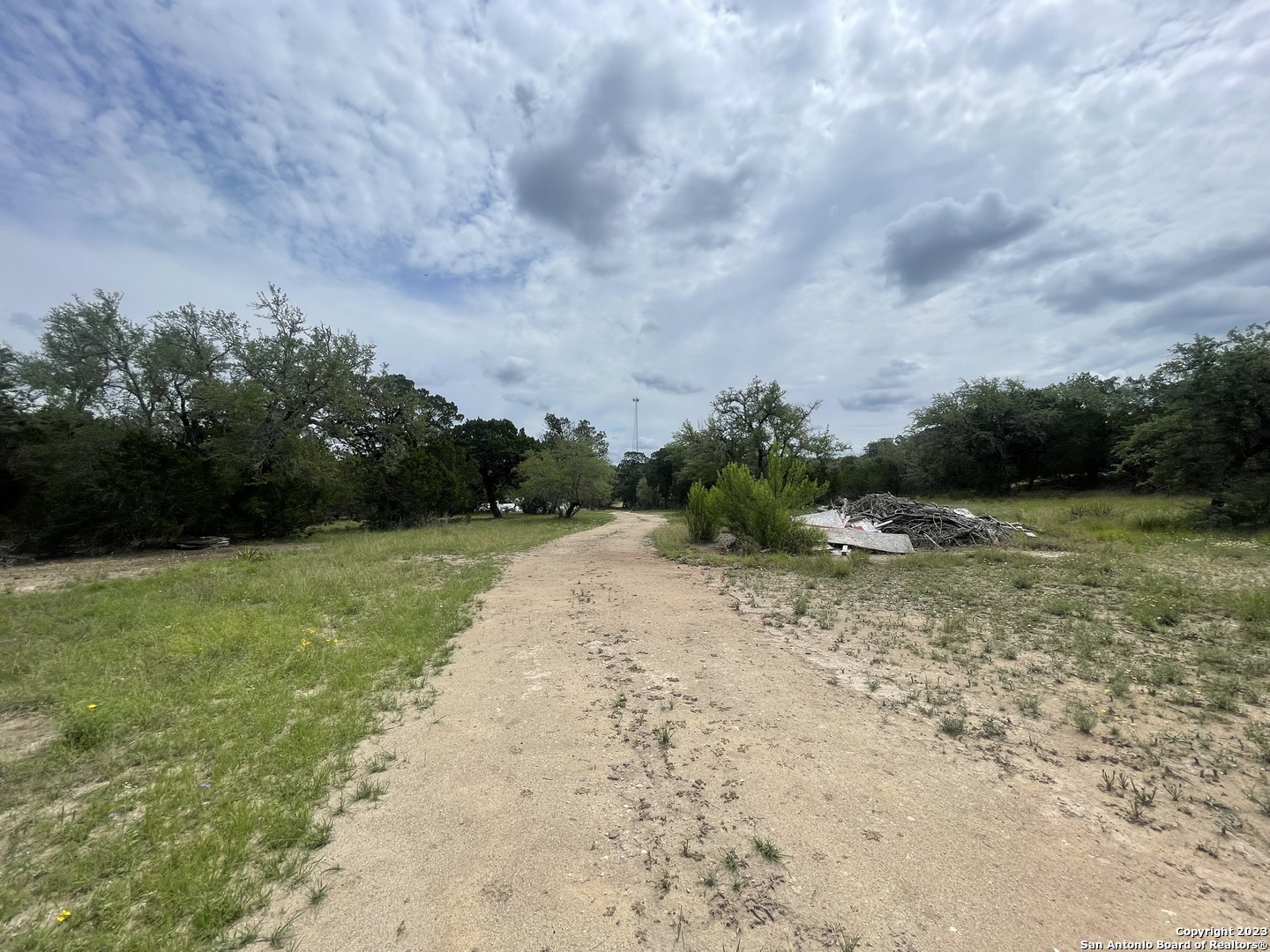 792 Alamo Beach Road, Unit A Pipe Creek, TX 78063 - Photo 18 of 18 a view of a dry yard with wooden fence