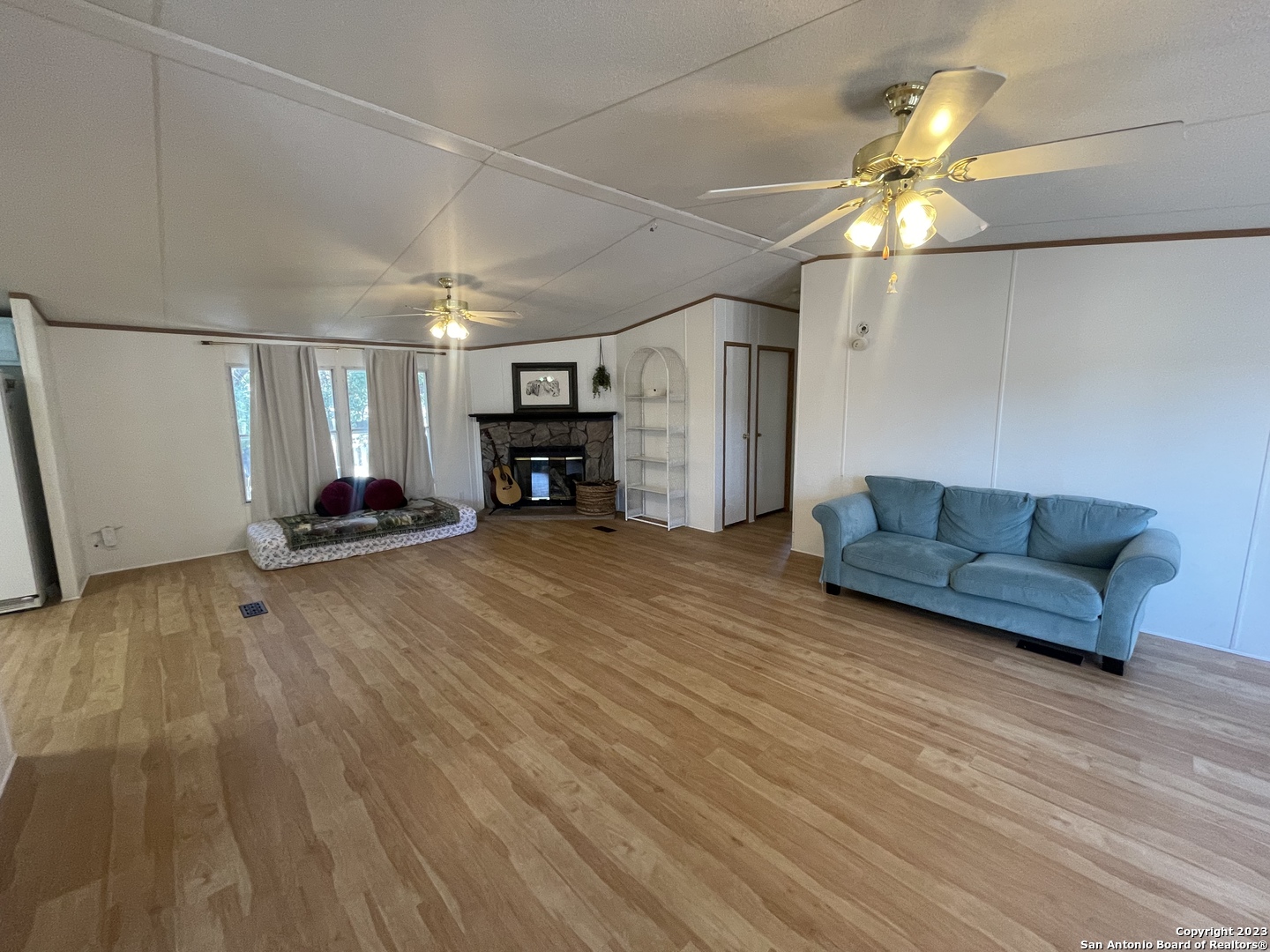 792 Alamo Beach Road, Unit A Pipe Creek, TX 78063 - Photo 2 of 18 a living room with furniture and a fireplace