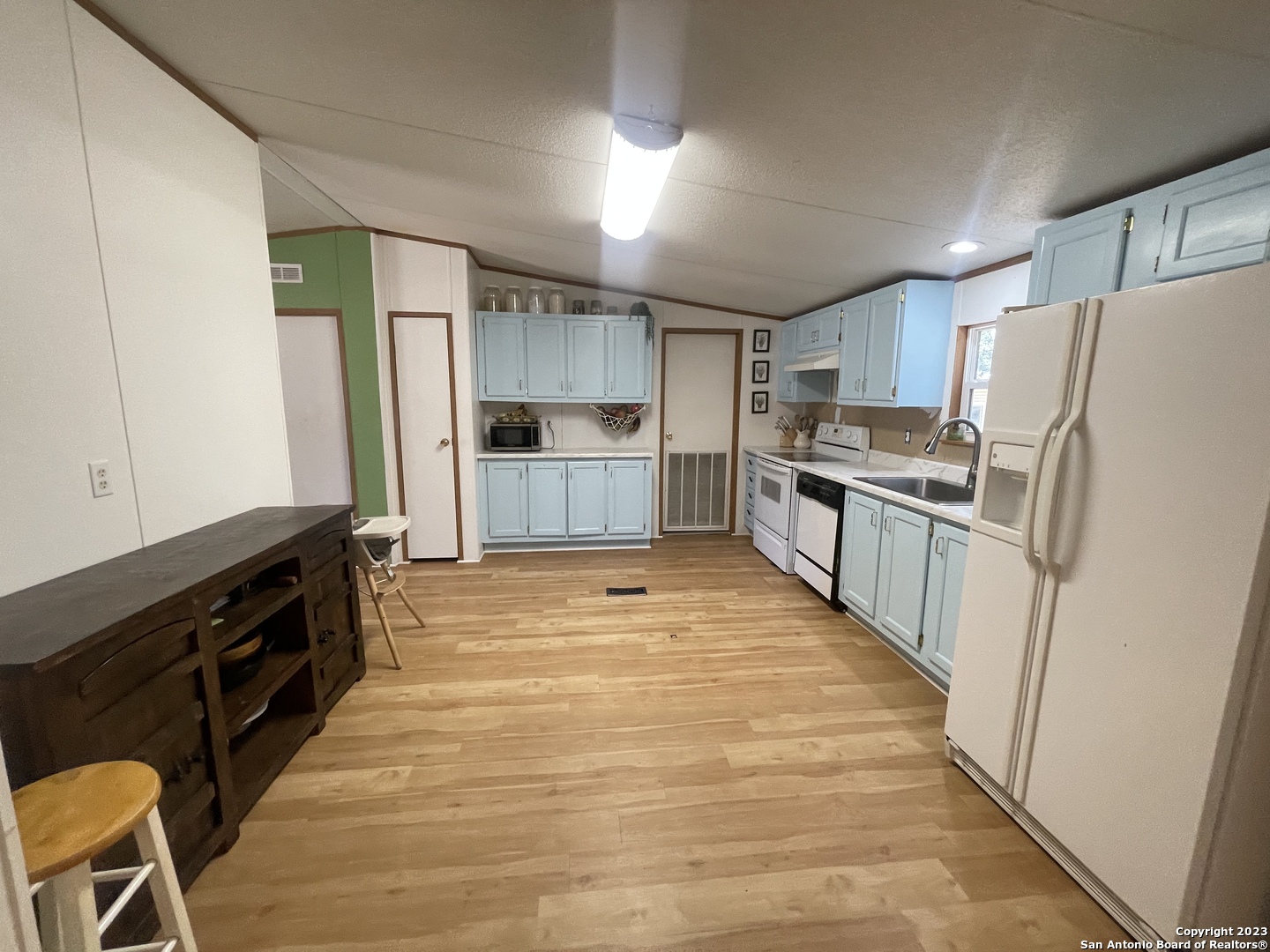 792 Alamo Beach Road, Unit A Pipe Creek, TX 78063 - Photo 3 of 18 a kitchen with granite countertop a refrigerator stove top oven and sink