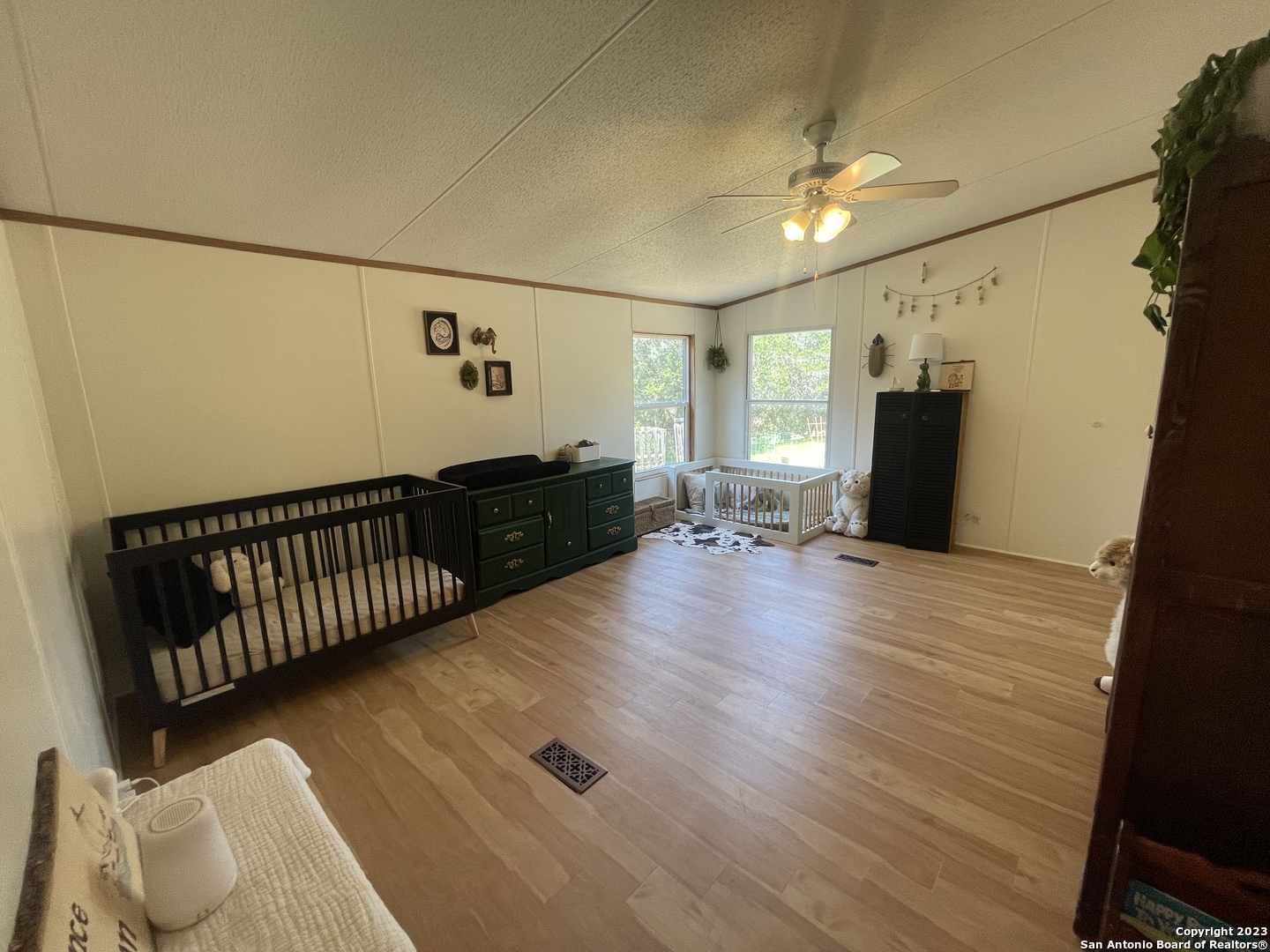 792 Alamo Beach Road, Unit A Pipe Creek, TX 78063 - Photo 5 of 18 a view of a hallway with wooden floor and furniture