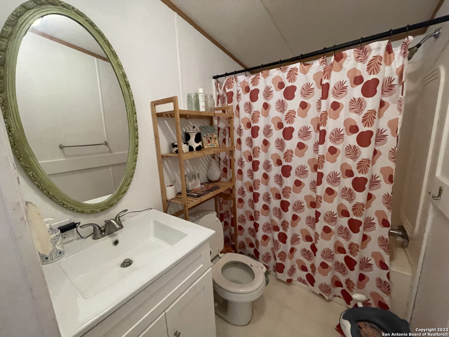 792 Alamo Beach Road, Unit A Pipe Creek, TX 78063 - Photo 6 of 18 a bathroom with a sink and mirror with toilet