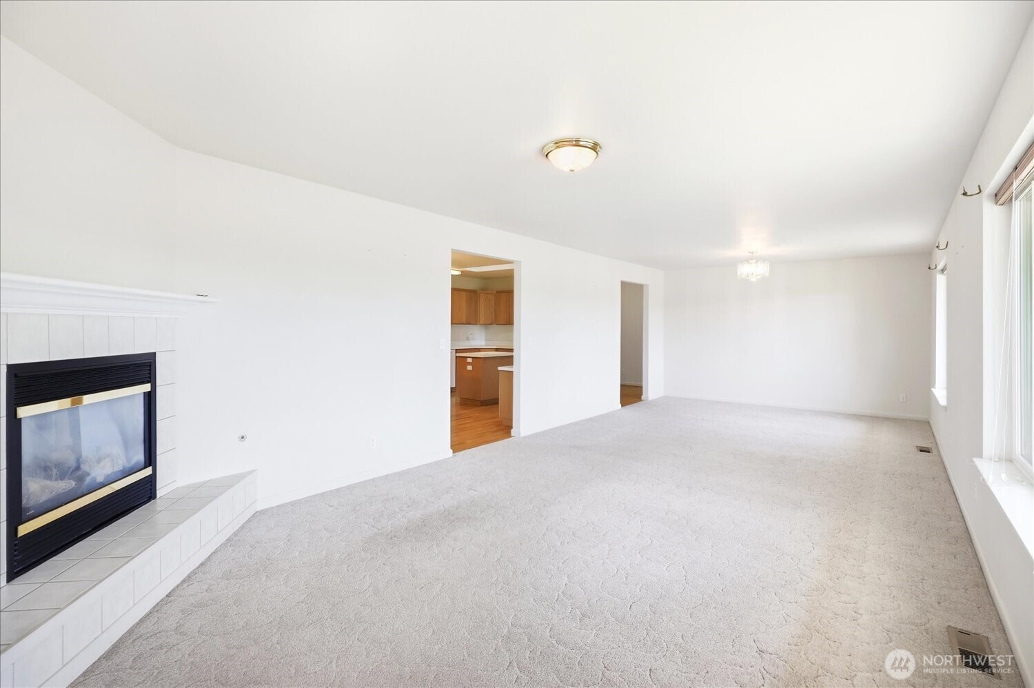221 Shane Porter Road Walla Walla, WA 99362 - Photo 4 of 38 a view of an empty room with a fireplace and a window