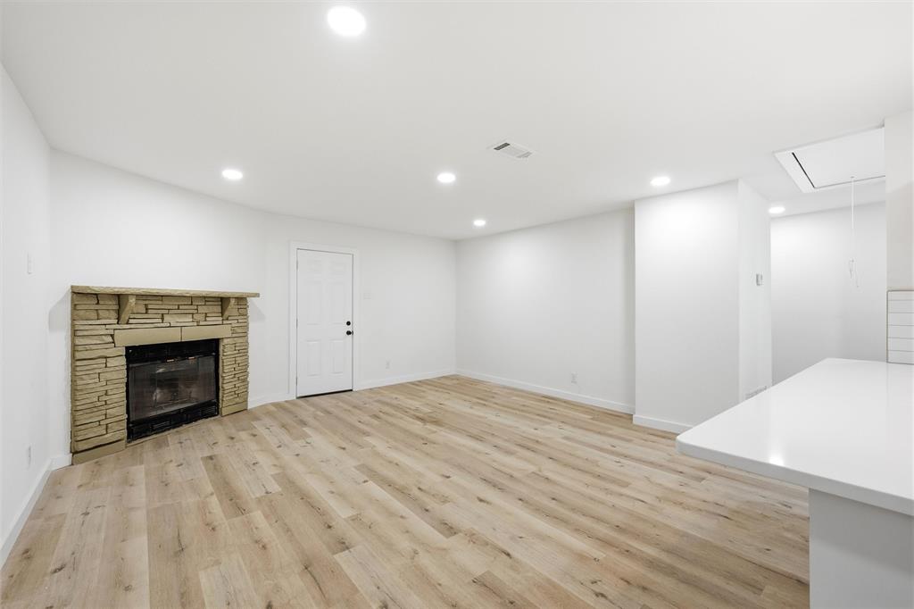 1221 Chestnut Street Waco, TX 76704 - Photo 15 of 32 a view of an empty room with a fireplace and a window