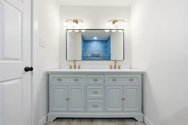 a bathroom with a sink and a mirror