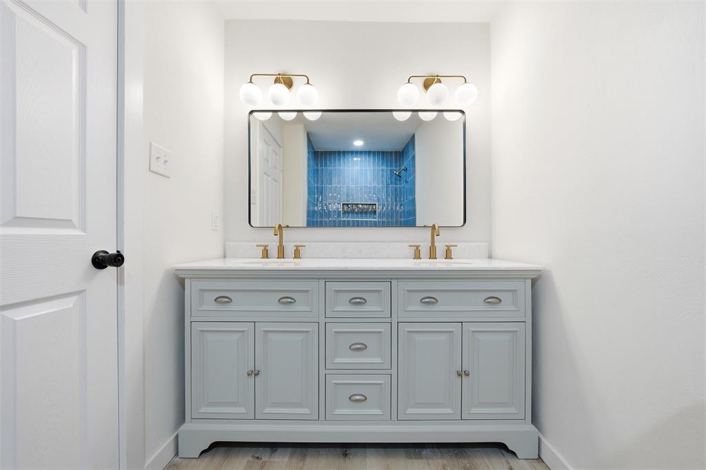 1221 Chestnut Street Waco, TX 76704 - Photo 17 of 32 a bathroom with a sink and a mirror