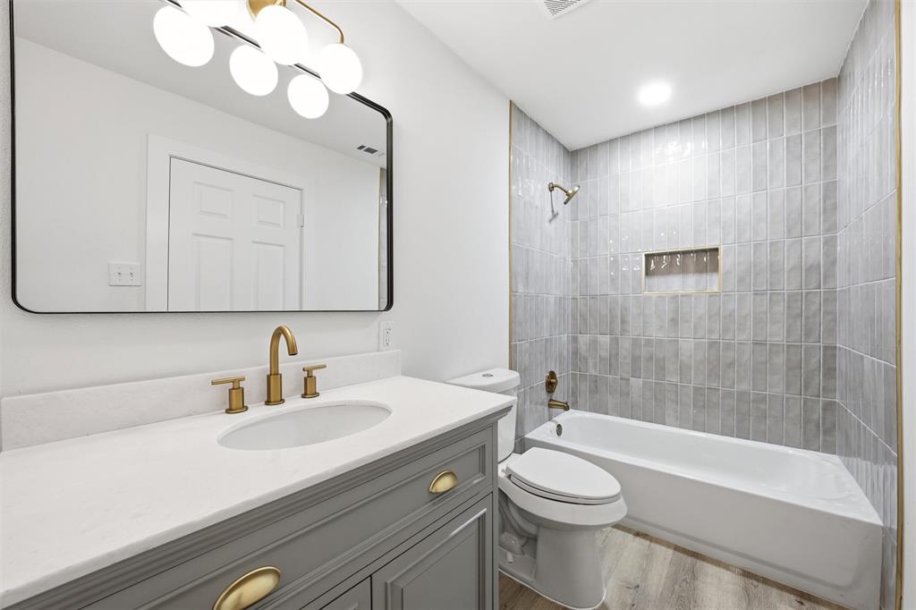 1221 Chestnut Street Waco, TX 76704 - Photo 21 of 32 a bathroom with a sink a toilet and shower
