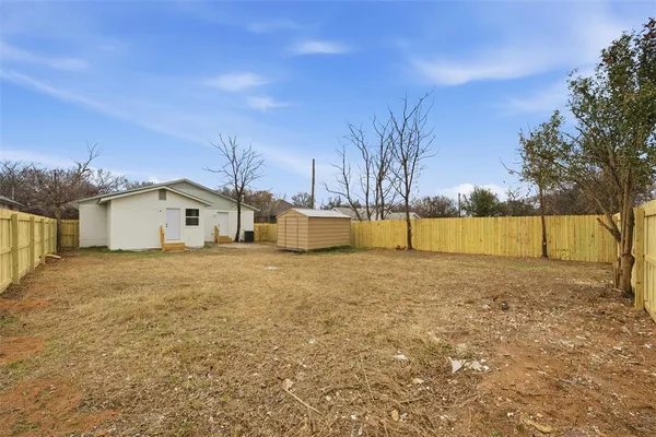 a view of a large white house with a yard