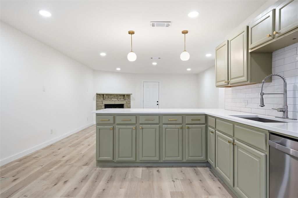 1221 Chestnut Street Waco, TX 76704 - Photo 10 of 32 a kitchen with a sink cabinets and wooden floor