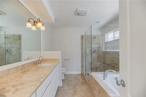 a bathroom with a tub sink and mirror