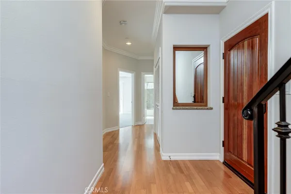 a view of hallway with stairs and wooden floor
