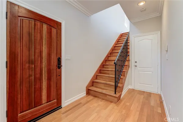 a view of a hallway with wooden floor and entryway