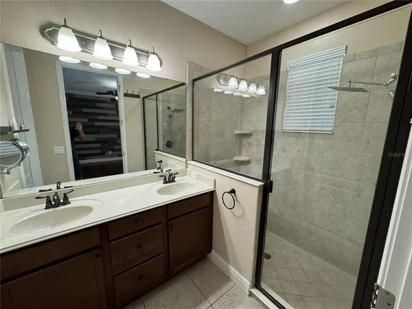 a bathroom with a double vanity sink a vanity and a mirror