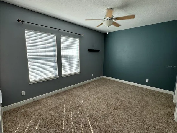 a view of a livingroom with a ceiling fan and window