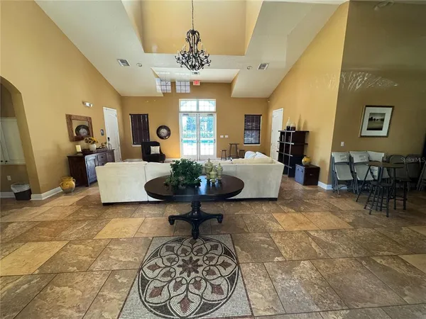 a living room with furniture and a chandelier