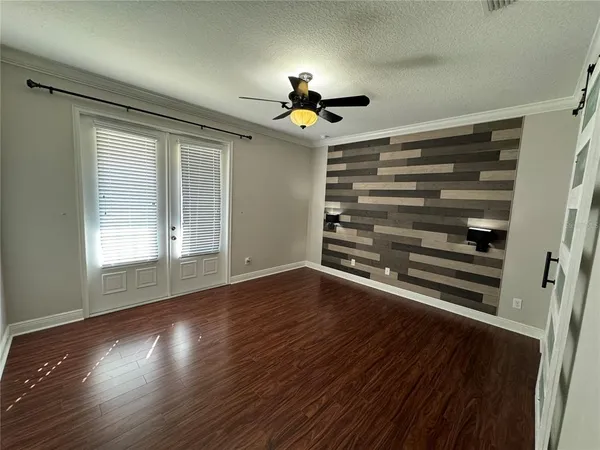 a view of a livingroom with wooden floor closet and window