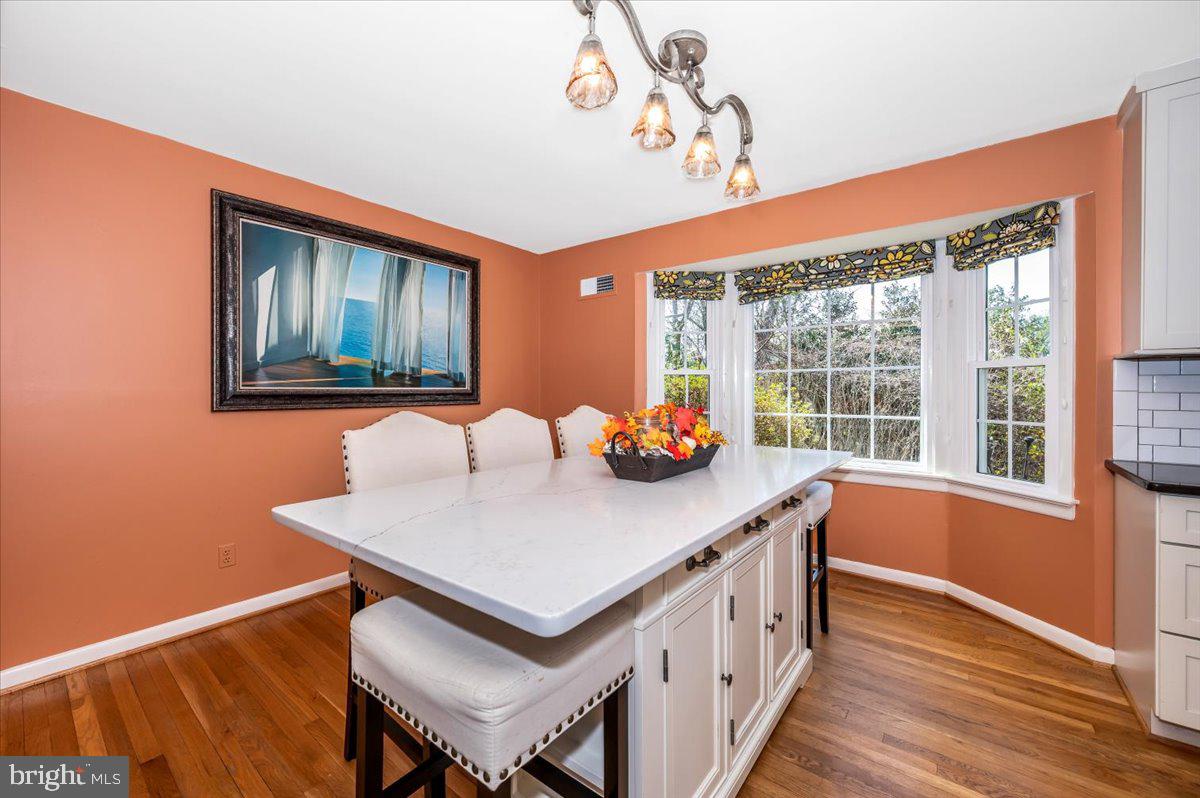 8803 Postoak Road Potomac, MD 20854 - Photo 12 of 66 a view of a room that has a table and chairs in it