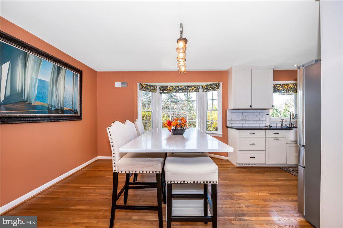 8803 Postoak Road Potomac, MD 20854 - Photo 13 of 66 a view of a dining room with furniture and wooden floor