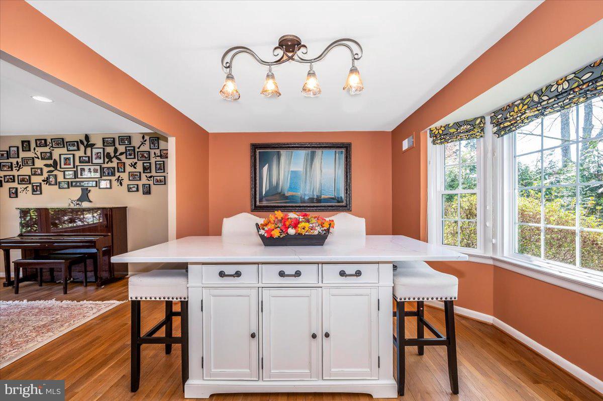 8803 Postoak Road Potomac, MD 20854 - Photo 14 of 66 a view of a dining room with furniture window and wooden floor