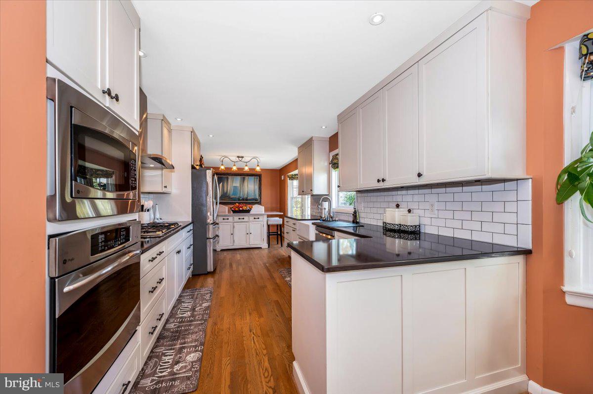 8803 Postoak Road Potomac, MD 20854 - Photo 15 of 66 a kitchen with stainless steel appliances granite countertop a sink stove and refrigerator