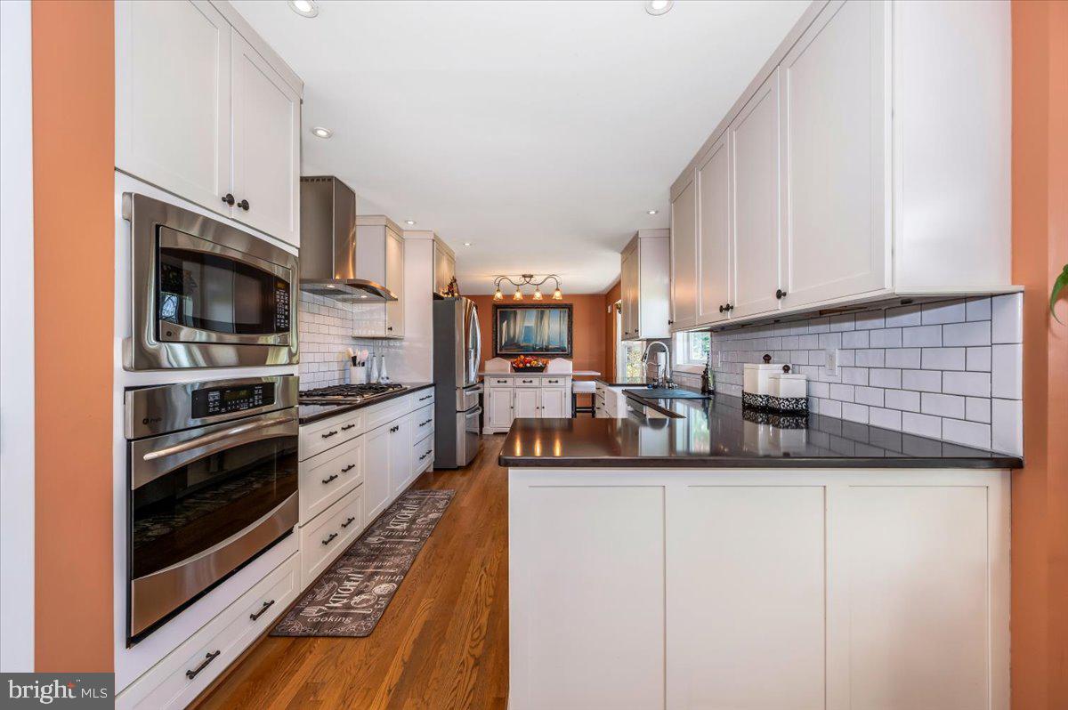 8803 Postoak Road Potomac, MD 20854 - Photo 16 of 66 a kitchen with stainless steel appliances granite countertop a refrigerator a stove and a sink