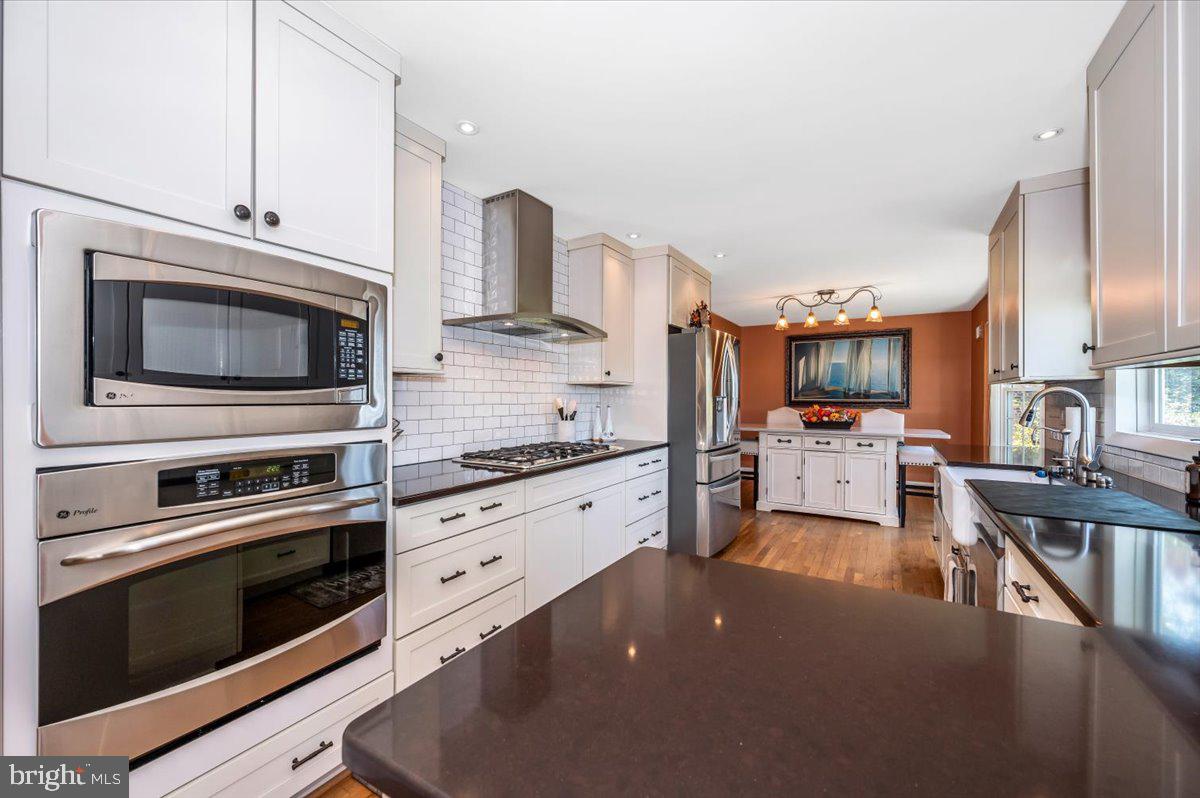 8803 Postoak Road Potomac, MD 20854 - Photo 17 of 66 a kitchen with granite countertop white cabinets and stainless steel appliances