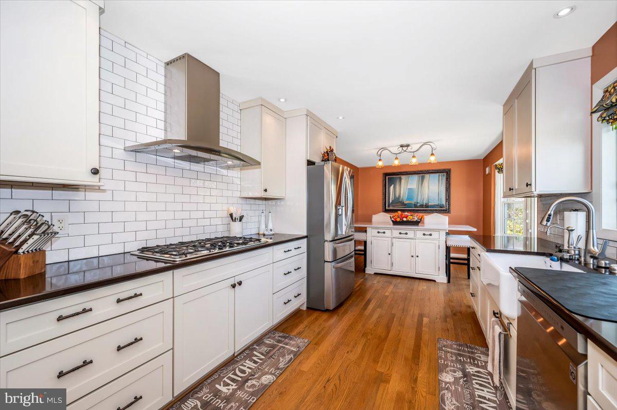 8803 Postoak Road Potomac, MD 20854 - Photo 18 of 66 a kitchen with granite countertop a sink stainless steel appliances and cabinets