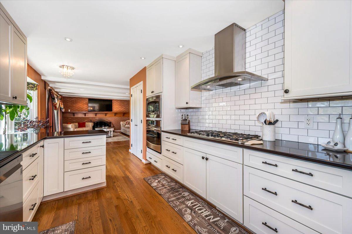8803 Postoak Road Potomac, MD 20854 - Photo 20 of 66 a kitchen with stainless steel appliances cabinets and a wooden floor