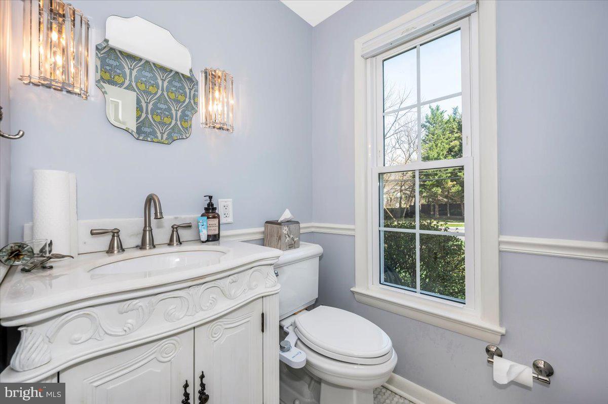 8803 Postoak Road Potomac, MD 20854 - Photo 26 of 66 a bathroom with a toilet sink and mirror