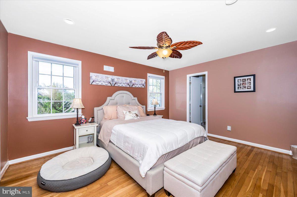 8803 Postoak Road Potomac, MD 20854 - Photo 27 of 66 a bedroom with a bed and a chandelier