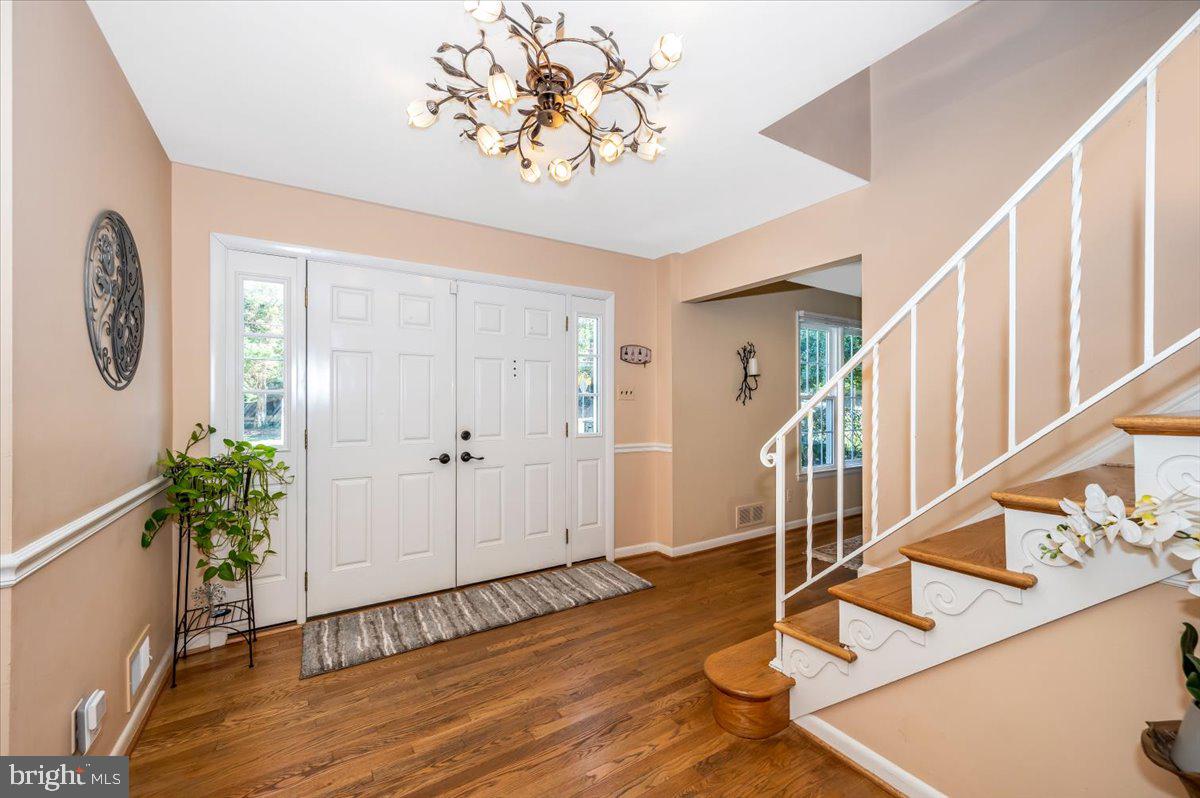 8803 Postoak Road Potomac, MD 20854 - Photo 3 of 66 a view of entryway and hall with wooden floor