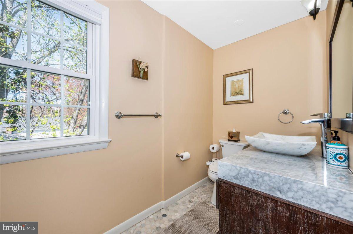 8803 Postoak Road Potomac, MD 20854 - Photo 31 of 66 a bathroom with a granite countertop sink and a mirror