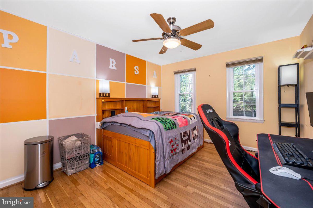 8803 Postoak Road Potomac, MD 20854 - Photo 34 of 66 a bed room with a bed and a chandelier