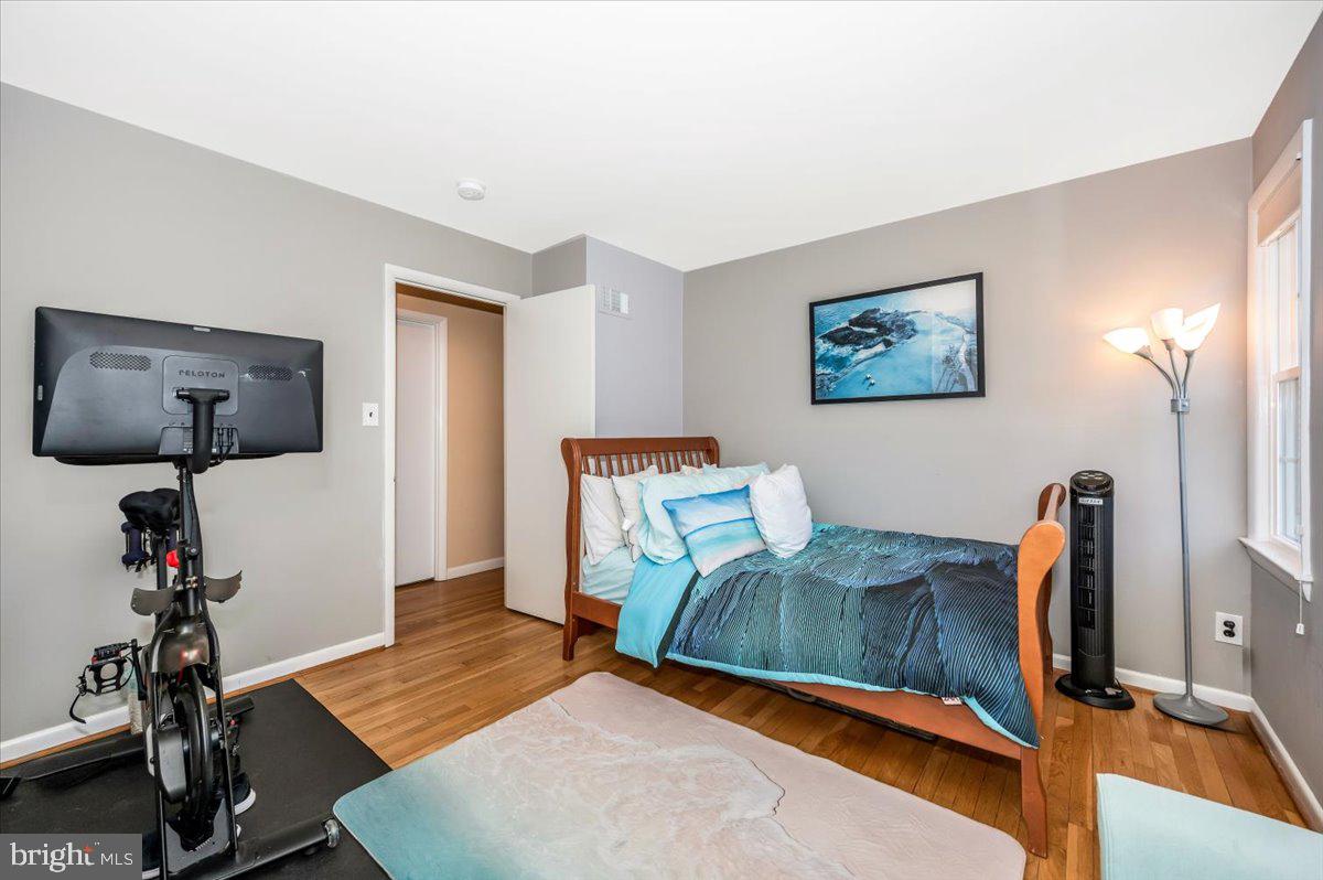 8803 Postoak Road Potomac, MD 20854 - Photo 37 of 66 a bedroom with furniture and a wooden floor