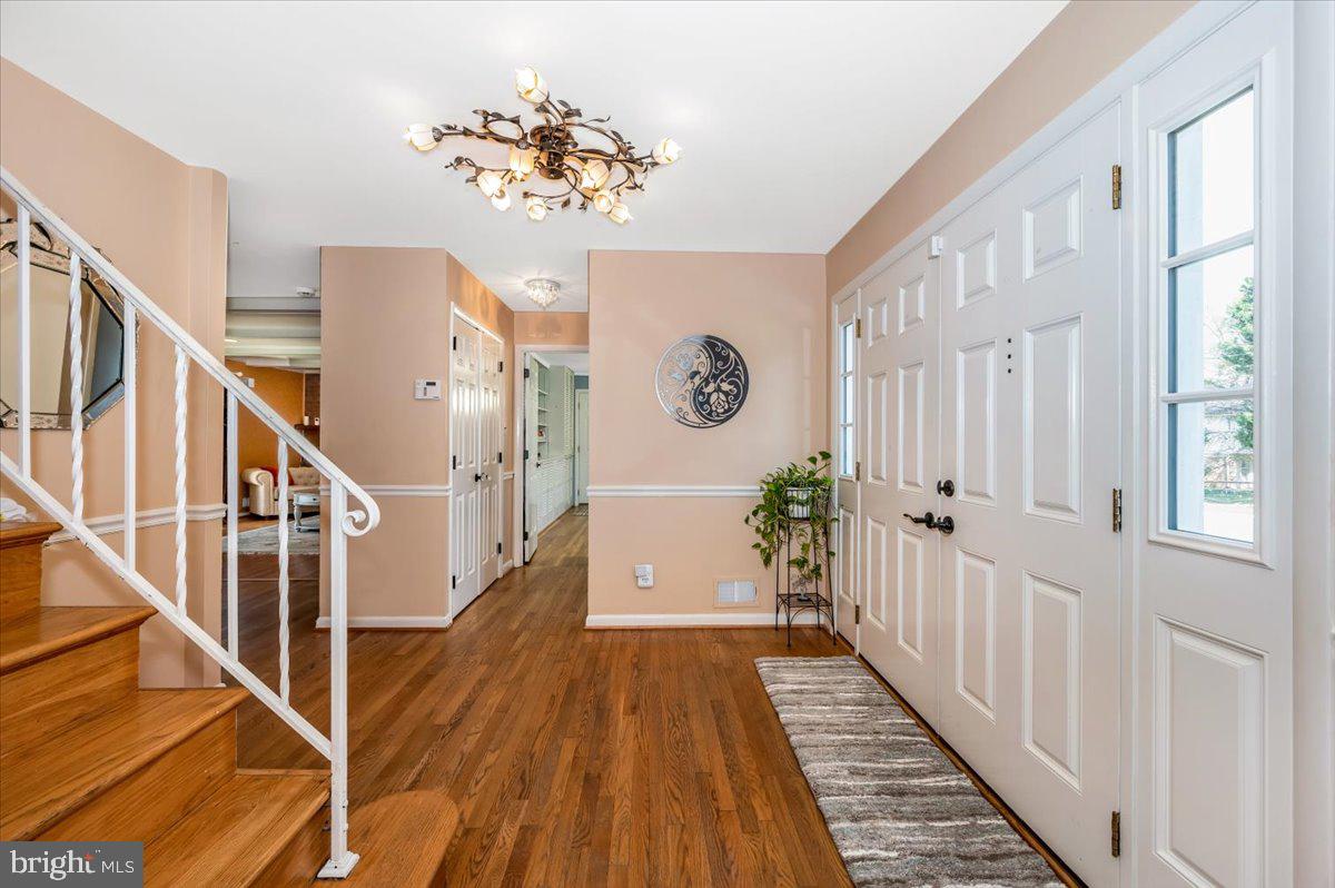 8803 Postoak Road Potomac, MD 20854 - Photo 4 of 66 a view of a hallway with wooden floor and staircase