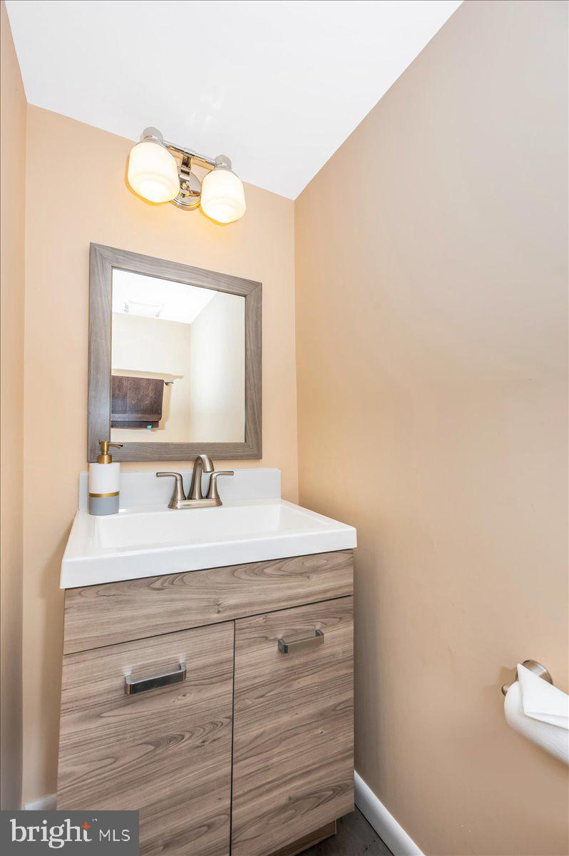 8803 Postoak Road Potomac, MD 20854 - Photo 46 of 66 a bathroom with a sink and a mirror