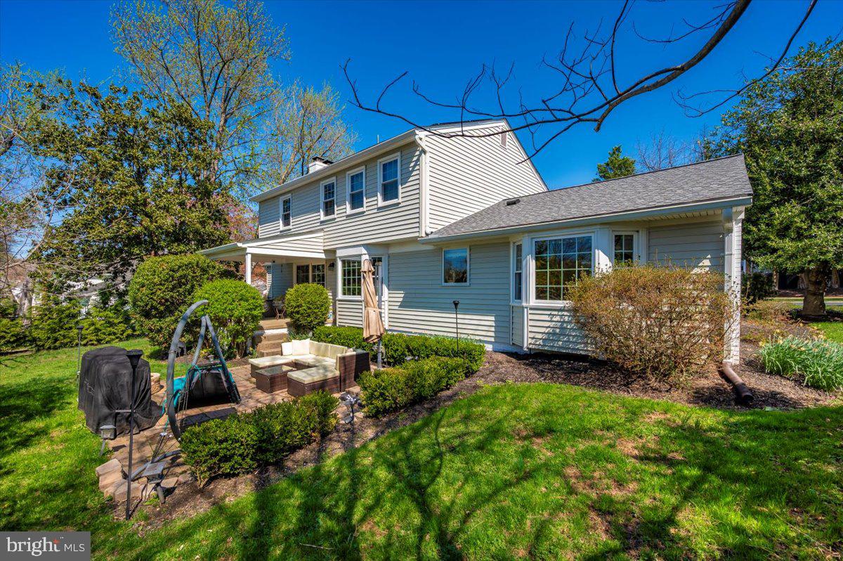 8803 Postoak Road Potomac, MD 20854 - Photo 50 of 66 a view of a house with brick walls and a yard with plants