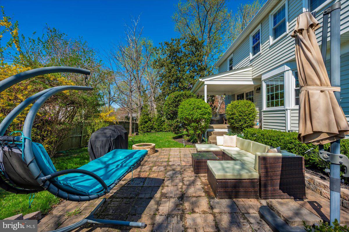 8803 Postoak Road Potomac, MD 20854 - Photo 59 of 66 a view of a chair and tables in the backyard of the house
