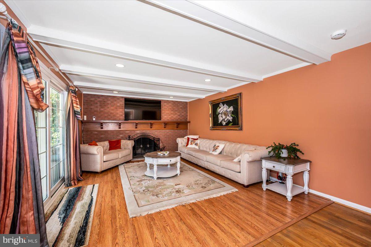 8803 Postoak Road Potomac, MD 20854 - Photo 6 of 66 a living room with furniture and a wooden floor
