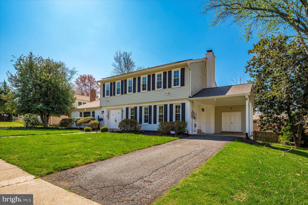 8803 Postoak Road Potomac, MD 20854 - Photo 64 of 66 a front view of a house with a garden and trees