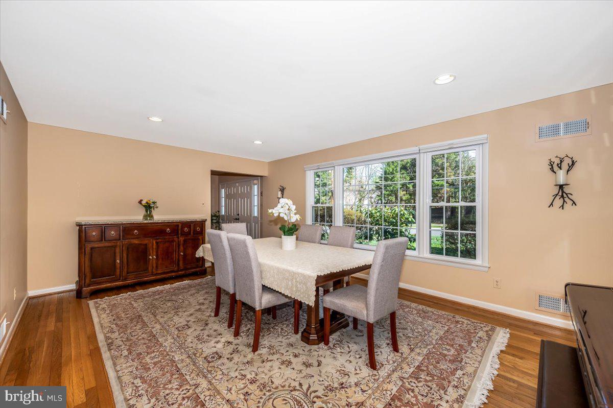 8803 Postoak Road Potomac, MD 20854 - Photo 9 of 66 a view of a dining room with furniture window and wooden floor