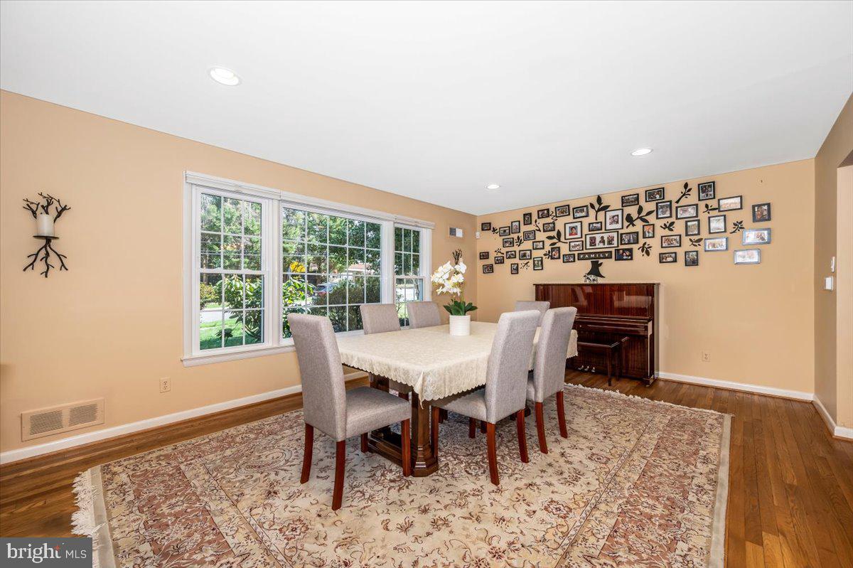 8803 Postoak Road Potomac, MD 20854 - Photo 10 of 66 a view of a dining room with furniture window and wooden floor